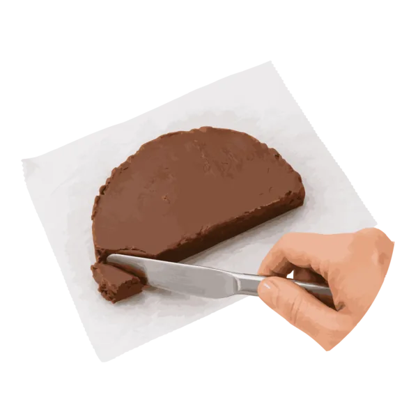 A bite being cut from a creamy piece of chocolate fudge