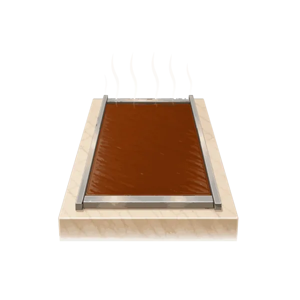 Fudge cooling inside a frame on a marble slab