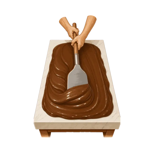Fudge being creamed by hand on a marble slab